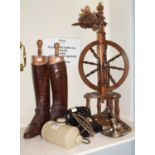 Spinning wheel, pair of tan leather riding boots with boot trees, black phone, chamberstick, a