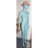 A turquoise shop mannequin of a woman wearing a stetson hat and another three quarter length