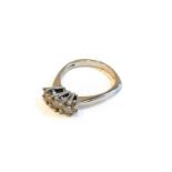 An 18 carat white gold diamond three stone ring, the round brilliant cut diamonds in claw