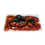 A collection of bead necklaces, including a coral branch necklace, cornelian, lapis lazuli,