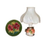 A Walter Moorcroft coral hibiscus lamp and a Walter Moorcroft hibiscus plate (2)