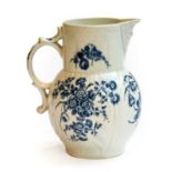 A Worcester leaf moulded mask jug, printed in underglaze blue with the three flowers pattern,