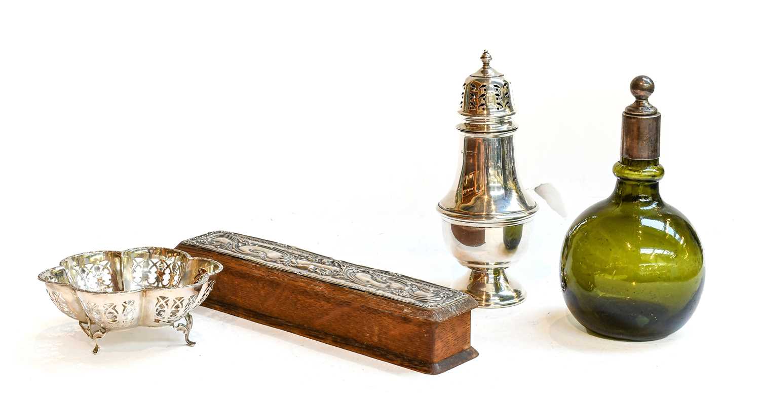 A collection of silver including: a silver-mounted green glass bottle; a caster, a silver-mounted