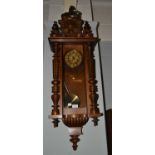 A walnut Vienna-type striking wall clock, circa. 1900, twin spring barrel movement, striking on a