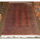 Pakistani Bukhara rug, the field with three columns of guls enclosed by hook gul borders, 190cm by