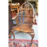 A Gothic revival ash and elm Windsor chair, with crinoline stretcher, dished seat and pointed