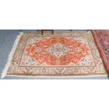 A Tabriz rug, the satsuma field with animals and flower heads around a mint green medallion,