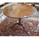 A George III mahogany circular tilt top tripod table 90cm by 69cm