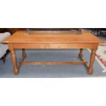 A modern 6ft blonde oak refectory table on turned and block supports 183cm by 90cm by 77cm