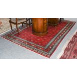 A fine-woven Bukhara carpet, the blood red field with columns of geometric motifs, enclosed by