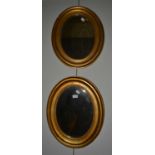 A pair of 19th-century gilt framed oval mirrors together with a Georgian fretwork mirror