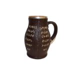 A Doulton Lambeth jug, in the style of an 18th century leather jack, inscribed with mottos and