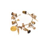 A figaro link bracelet, stamped '9' and '.375', hung with various charms including a hunting horn, a