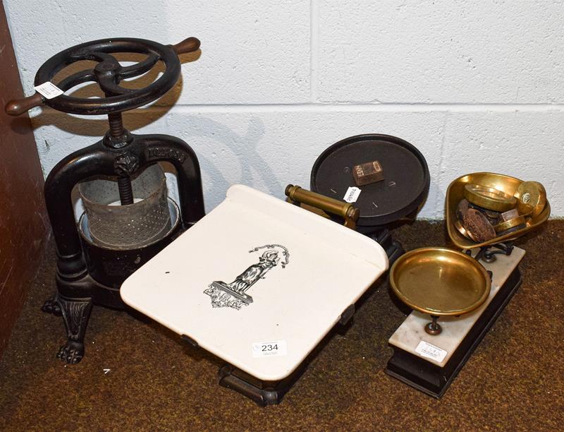 A pair of Victorian cast iron and brass grocers scales with printed pottery table, together with a