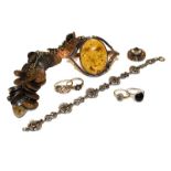 A collection of jewellery including an amber bangle, two 9 carat gold cluster rings (a.f.), two