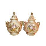 A matched pair of Royal Worcester vases and covers, c1917/1919 of ovoid form with scroll handles the