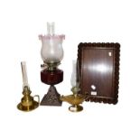 A carved oak serving tray, two Victorian brass based chamber lamps and an oil lamp with amethyst