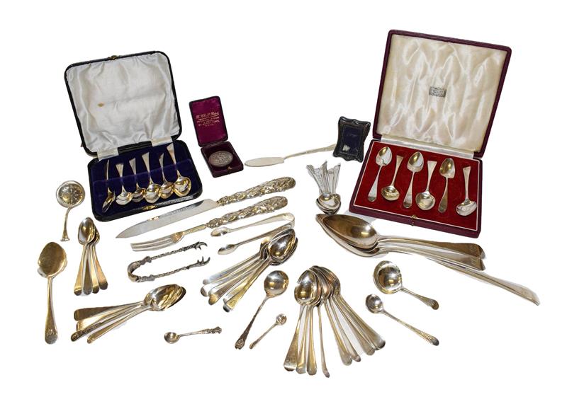 A collection of assorted silver flatware of various patterns, including a George IV silver basting