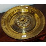 A 16th/17th century Nuremburg brass alms dish with central ornate boss within a band of Gothic