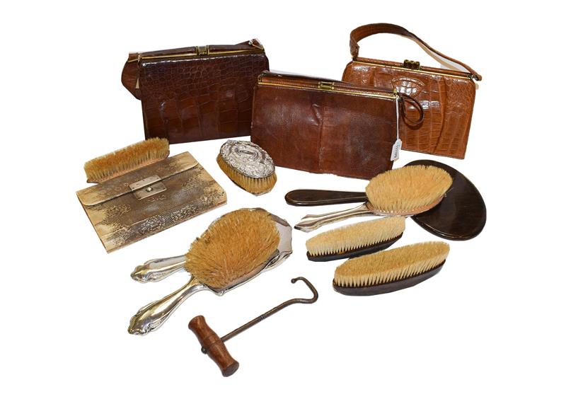 A snakeskin manicure case with mother of pearl fittings, a silver backed hand mirror and brush,