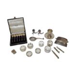 A collection of assorted silver, including six various napkin rings, a cup on stand, a pair of