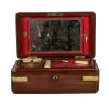 An early 19th century mahogany campaign gentleman's vanity box, brass bound and with leather