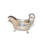 An Edward VII silver sauce boat by Henry Atkin, Sheffield, 1905, boat shaped and on three pad feet
