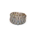 A diamond ring, formed of graduated undulating panels set throughout with eight-cut diamonds, in