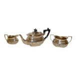 A three-piece Victorian silver tea-service, London, 1895, each piece with part-fluted lower body,