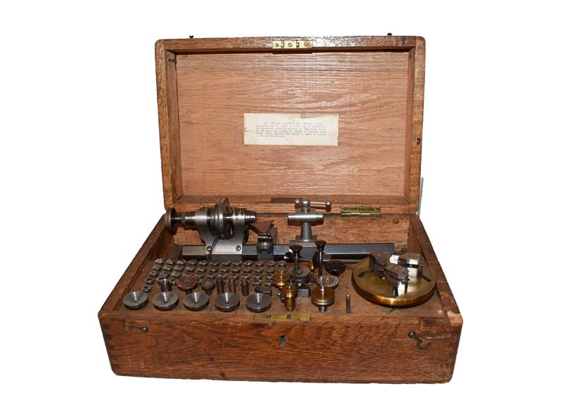 A TCM Co Ltd London watchmakers lathe with collets, in wooden box