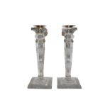 A pair of George VI silver mounted cut glass candlesticks, the silver mounts by John Grinsell &