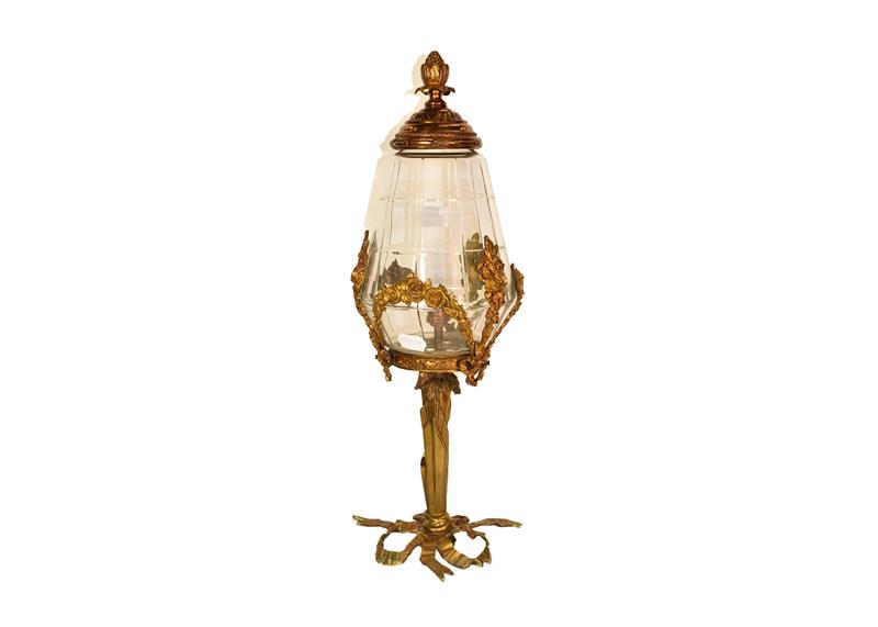 A French ormolu and glass lamp with ribbon and foliate swag detail, 55cm high. Not wired. Visble