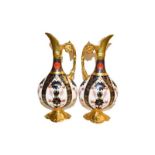 A pair of Royal Crown Derby ewers in Imari pattern 1128, 25cm (2). One marked as second quality, the