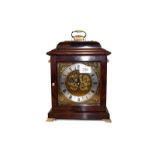 A modern mahogany cased table clock on brass bracket feet, with 6'' brass square dial having