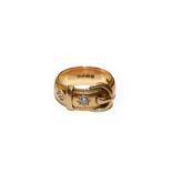 An 18 carat gold diamond buckle ring, finger size S1/2. Gross weight 13.1 grams.