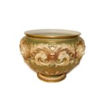 Royal Worcester jardiniere moulded with lion masks and scroll work on a gilt ground with printed