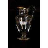 A Baccarat glass jug, with flat cut collar, etched band of daisy heads, gilt rims and a gilt