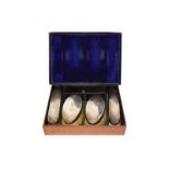 A set of four silver brushes, William Comyns, London 1910, in a fitted leather case, engraved MJP