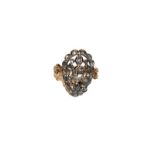 A diamond ring, the pear shaped pierced plaque set throughout with old cut and vari-cut diamonds, in