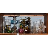 A quantity of Victorian and later oil lamps and chamber lamps including coloured glass examples