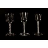 Three Georgian wine glasses raised on double series opaque twist stems (3). All with foot chips.