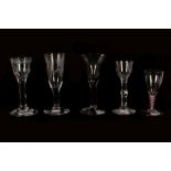 Five Georgian glasses including three wine glasses on having double series opaque and red twist