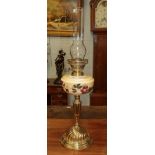 A Victorian brass based oil lamp with painted glass resivoir chimney, 46cm not including chimney