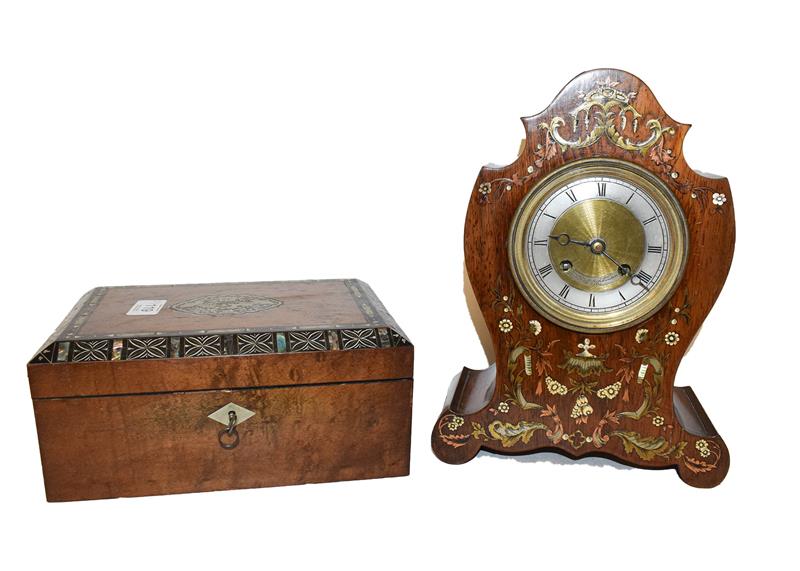 A 19th century French rosewood cased mantel clock with mixed metal inlays, brass and silvered dial