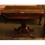 An early Victorian rosewood fold-over card table with octagonal baluster centre pedestal on four