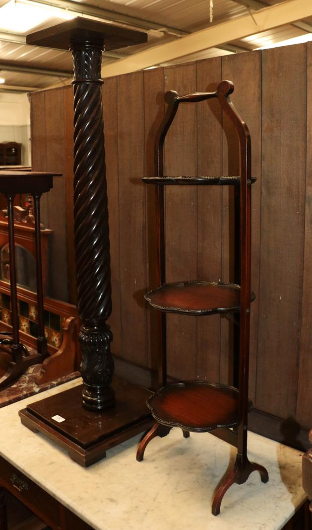 A mahogany jardiniere stand with barley twist and acanthus carved column, plinth base with a folding