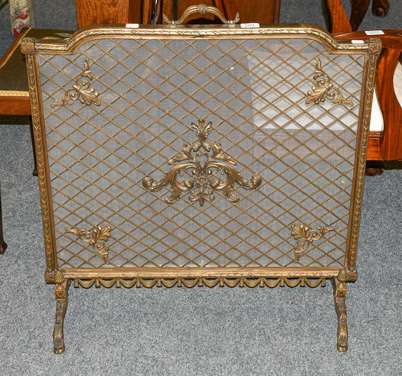 A 20th century brass spark guard, with mesh panel adorned with scrolls, 73cm by 78cm