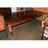 A Victorian mahogany extending dining table with three additional leaves, raised on octagonal