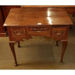 An 18th century style oak lowboy, the front with three small drawers and pad shaped feet, 80cm by