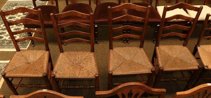 A set of four early 19th century elm ladder back rush seated chairs